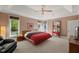 Relaxing bedroom with tray ceilings, a ceiling fan, neutral walls, and tree-filled outdoor views at 108 Martinique Pl, Cary, NC 27511