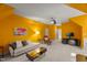 Large bonus room features neutral carpet, yellow walls, comfortable seating, and a entertainment area at 108 Martinique Pl, Cary, NC 27511