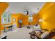 Spacious bonus room with bright yellow walls, a comfortable seating area, and a dedicated workspace at 108 Martinique Pl, Cary, NC 27511