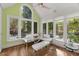 Inviting breakfast area with glass table, ample natural light, and outdoor pool view at 108 Martinique Pl, Cary, NC 27511