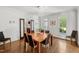 Elegant dining room with a modern chandelier and views of the well-manicured outdoor space at 108 Martinique Pl, Cary, NC 27511
