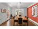 Well-lit dining room with views of the staircase and a vibrant wall with an eye-catching art piece at 108 Martinique Pl, Cary, NC 27511
