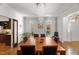 Bright dining room featuring a modern chandelier and views into the adjacent living spaces at 108 Martinique Pl, Cary, NC 27511