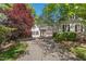 Beautiful home with a circular driveway and brick path featuring a front exterior surrounded by lush greenery at 108 Martinique Pl, Cary, NC 27511