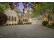 Charming home featuring a circular driveway, three-car garage, and welcoming front entrance with manicured landscaping at 108 Martinique Pl, Cary, NC 27511