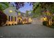Charming home featuring a circular driveway, three-car garage, and welcoming front entrance with manicured landscaping at 108 Martinique Pl, Cary, NC 27511