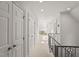 Bright hallway with white walls, trim, and carpet, connecting various rooms with elegant doors at 108 Martinique Pl, Cary, NC 27511