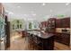 Open-concept kitchen with a large island, custom cabinetry, and views of the living space at 108 Martinique Pl, Cary, NC 27511