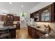 Stunning kitchen with custom cabinetry, granite countertops, and a staircase view at 108 Martinique Pl, Cary, NC 27511
