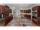 Spacious kitchen featuring an expansive island, dark wood cabinets and stainless steel appliances at 108 Martinique Pl, Cary, NC 27511