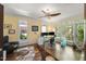 Bright home office featuring hardwood floors, a glass desk, and multiple windows offering scenic views at 108 Martinique Pl, Cary, NC 27511