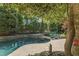 Inviting backyard pool area featuring stone accents, lounge chairs, and verdant greenery at 108 Martinique Pl, Cary, NC 27511
