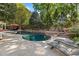 Backyard swimming pool surrounded by stone hardscaping and lush landscaping at 108 Martinique Pl, Cary, NC 27511