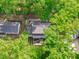 Aerial view showcases the property's layout, outdoor seating, mature trees, nestled within a lush neighborhood at 1107 Daleland Dr, Raleigh, NC 27612