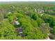 An aerial view of a community with mature trees and other greenery nestled within a suburban landscape at 1107 Daleland Dr, Raleigh, NC 27612