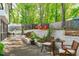 Backyard with brick accents, multiple seating areas, a greenhouse, and lush landscaping at 1107 Daleland Dr, Raleigh, NC 27612