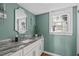 Stylish bathroom with a granite countertop, modern fixtures, and natural light from the window at 1107 Daleland Dr, Raleigh, NC 27612