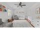 Bedroom with hardwood floors, ample natural light, ceiling fan, and an area rug at 1107 Daleland Dr, Raleigh, NC 27612