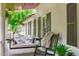 Inviting porch features a cozy porch swing and rocking chair at 1107 Daleland Dr, Raleigh, NC 27612