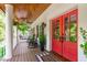 Covered porch with red double doors, ceiling fan, and space for seating at 1107 Daleland Dr, Raleigh, NC 27612