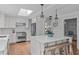 Modern kitchen featuring white cabinets, a large island, and stainless steel appliances at 1107 Daleland Dr, Raleigh, NC 27612
