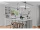 Bright, stylish kitchen features a center island with seating, light cabinets, and natural light at 1107 Daleland Dr, Raleigh, NC 27612