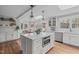 Spacious kitchen with white cabinetry, stainless steel appliances, and a central island at 1107 Daleland Dr, Raleigh, NC 27612