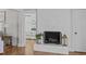 Bright living room featuring a decorative fireplace, hardwood floors, and adjacent bedroom view at 1107 Daleland Dr, Raleigh, NC 27612
