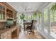 Bright office with hardwood floors, multiple windows, ceiling fan, and custom cabinets and desk at 1107 Daleland Dr, Raleigh, NC 27612
