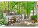 Cozy backyard patio area with brick planters, seating, and access to a landscaped garden with play area at 1107 Daleland Dr, Raleigh, NC 27612
