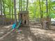 A backyard play structure with a slide, swings, climbing wall, platform and more, providing entertainment at 1107 Daleland Dr, Raleigh, NC 27612