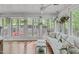 Sunroom boasting a wall of windows, hardwood flooring, and a comfortable white sofa at 1107 Daleland Dr, Raleigh, NC 27612