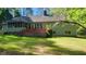 Spacious backyard featuring a deck, screened-in porch, and lush greenery at 113 Colonial Dr, Wendell, NC 27591