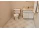 Powder room features a toilet, vanity with storage, and classic tile flooring at 113 Colonial Dr, Wendell, NC 27591