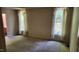 This large bedroom features neutral walls, carpeted floors, and windows with sheer white curtains at 113 Colonial Dr, Wendell, NC 27591