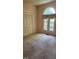 This bedroom features neutral walls, carpeted floors, a large window, and a closet with doors at 113 Colonial Dr, Wendell, NC 27591
