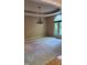 This dining room features a decorative light fixture, neutral walls, and a large window for natural light at 113 Colonial Dr, Wendell, NC 27591