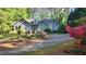 Charming home with mature landscaping, flowering bushes and a circular driveway at 113 Colonial Dr, Wendell, NC 27591