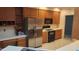 This spacious kitchen features stainless steel appliances, wooden cabinets, and a breakfast bar at 113 Colonial Dr, Wendell, NC 27591