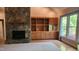 Spacious living room with stone fireplace, built-in cabinets, and large windows at 113 Colonial Dr, Wendell, NC 27591