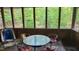 Cozy screened porch with table and chairs overlooking lush greenery at 113 Colonial Dr, Wendell, NC 27591