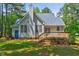 Back of house featuring a chimney, gray siding, and a small deck at 123 Alan Ln, Clayton, NC 27520