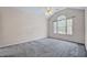 Bright bedroom featuring vaulted ceilings, large windows, and neutral carpeting at 123 Alan Ln, Clayton, NC 27520