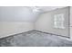 Bedroom featuring an angled ceiling, carpeting, and a window at 123 Alan Ln, Clayton, NC 27520