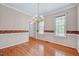 The dining room features hardwood floors, and a decorative border along the wall at 123 Alan Ln, Clayton, NC 27520