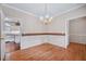 Dining room with hardwood floors and a chandelier, with entryways into other rooms at 123 Alan Ln, Clayton, NC 27520