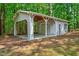 Detached garage with a carport located on a wooded lot at 123 Alan Ln, Clayton, NC 27520