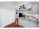 Open kitchen layout with white cabinets, countertops, and stainless steel appliances at 123 Alan Ln, Clayton, NC 27520