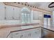 Bright kitchen featuring a double sink, and neutral countertop, with white cabinetry at 123 Alan Ln, Clayton, NC 27520
