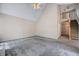 Spacious living room featuring vaulted ceilings, stairs, and neutral gray carpeting at 123 Alan Ln, Clayton, NC 27520